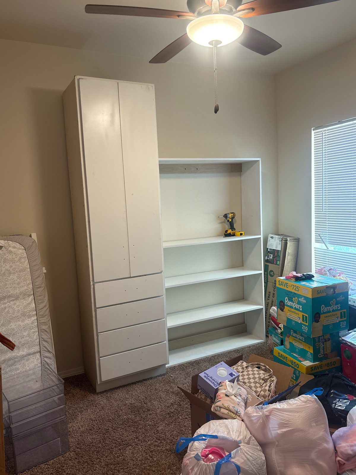 White closet wardrobe with drawers and open shelving built for a newborn's room